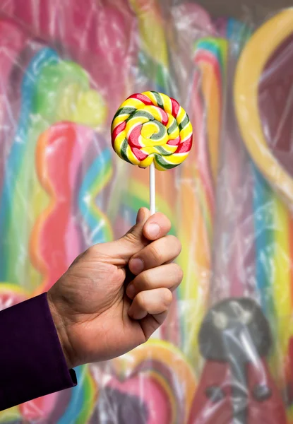 Lollipop in male hand — Stock Photo, Image