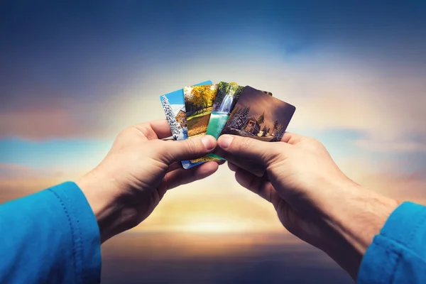 Male hands holding seasons cards — Stock Photo, Image