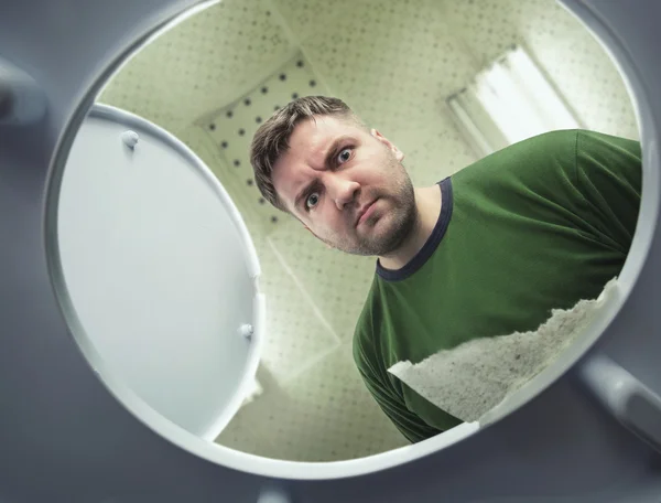 Man looking in toilet bowl — Stock Photo, Image