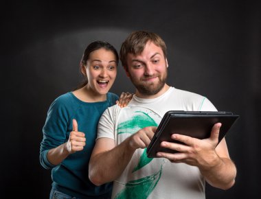 Couple playing with tablet clipart