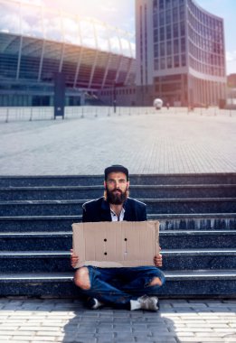 Karton parçalar ile oturan evsiz