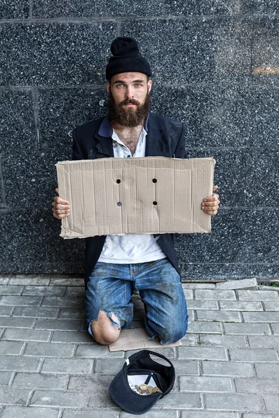 Begar with piece of cardboard — Stock Photo, Image