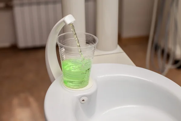 Tooth wash in plastic cup — Stock Photo, Image