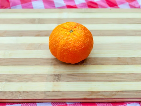 Ripe orange on board — Stock Photo, Image