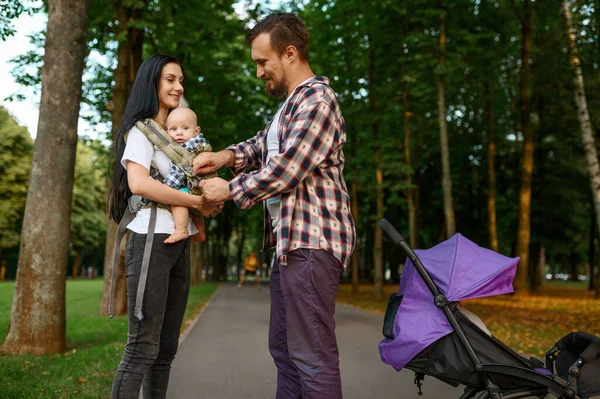 Ouders en kleine baby wandelen langs de steeg — Stockfoto