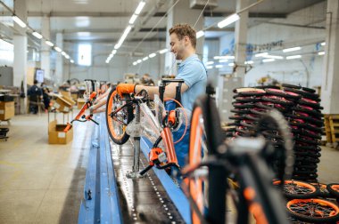 Bicycle factory, worker at assembly line, chain installation. Male mechanic in uniform installs cycle parts in workshop, industrial manufacturing clipart
