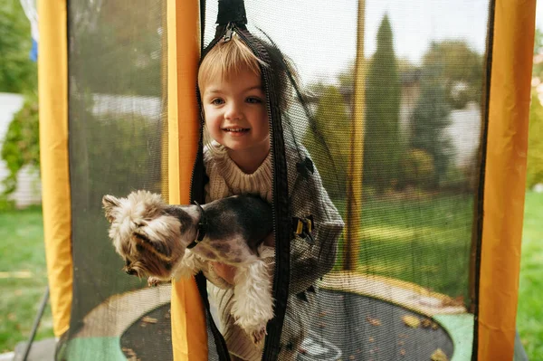 Kid Holds Funny Dog Trampoline Garden Best Friends Child Puppy — Stock Photo, Image