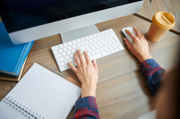 Female IT specialist hands on keyboard in office