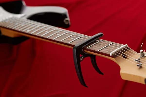 Electric Guitar Fretboard Capodaster Closeup Red Background Nobody String Musical — Stock Photo, Image