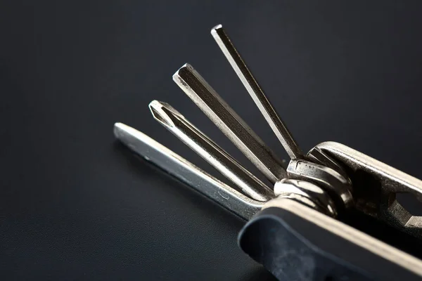 Folding screwdriver with different bits, closeup — Stock Photo, Image