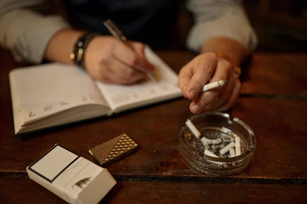 Man Smokes Cigarette Writes Notebook Wooden Tabler Background Tobacco Smoking — Stock Photo, Image