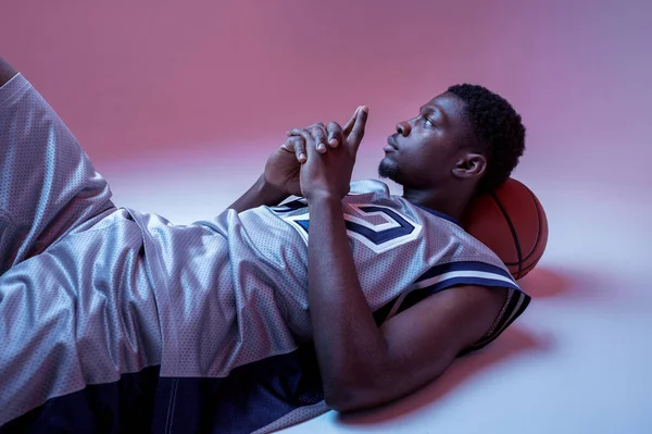 Basketball Player Lying Ball Studio Neon Background Professional Male Baller — Foto de Stock