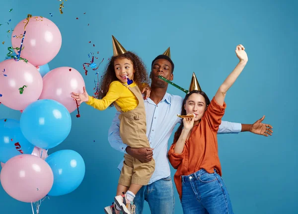 Счастливая семья празднует день рождения на голубом фоне — стоковое фото