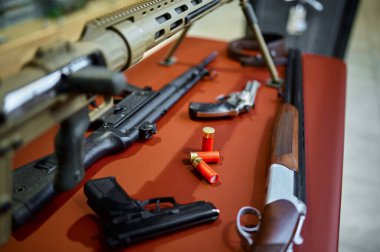 Rifles and pistols on counter in gun store closeup, nobody. Weapon shop interior on background, ammunition assortment, firearms choice, shooting hobby and lifestyle, self protection and security clipart