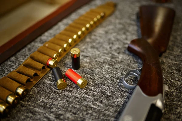 Hunting rifle, bandolier and cartridges, gun store — Stock Photo, Image