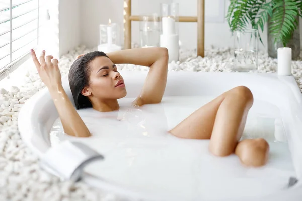 Sexy woman with glass in bath with milk — Stock Photo, Image