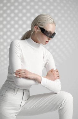 Model in white clothes and futuristic glasses