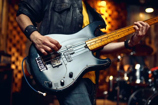 Brutal musician with electric guitar on stage — Stock Photo, Image