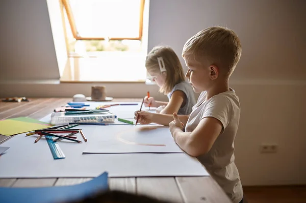 Zwei Kinder zeichnen mit Bleistift und Filzstift — Stockfoto