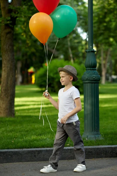 Boy with air balloons waiting for a girl — Stock Photo, Image