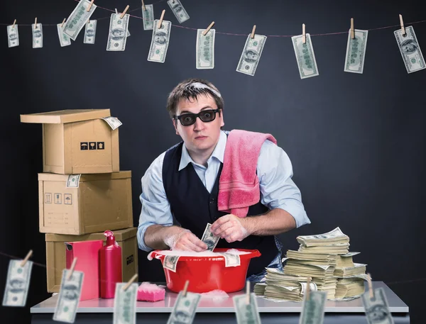 Scared businessman is laundering dollars — Stock Photo, Image