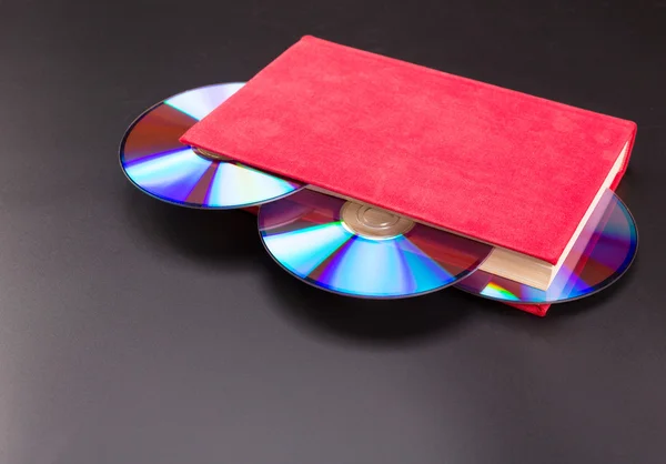 Disks in book — Stock Photo, Image