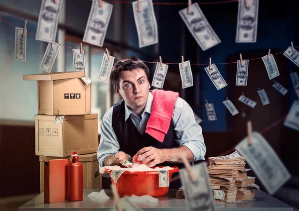 Scared businessman is laundering money — Stock Photo, Image