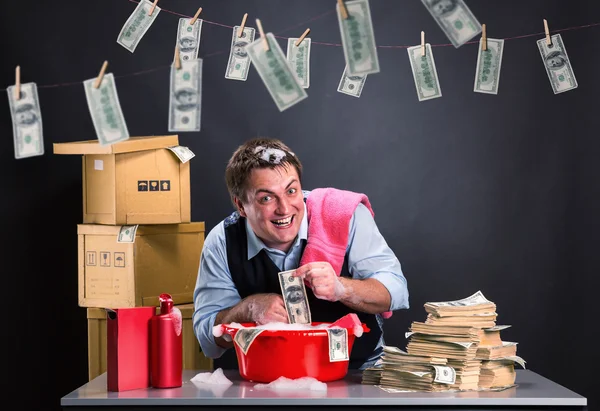 Happy businessman is laundering money — Stock Photo, Image