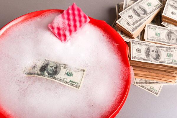 Dollars banknotes are washing in foam