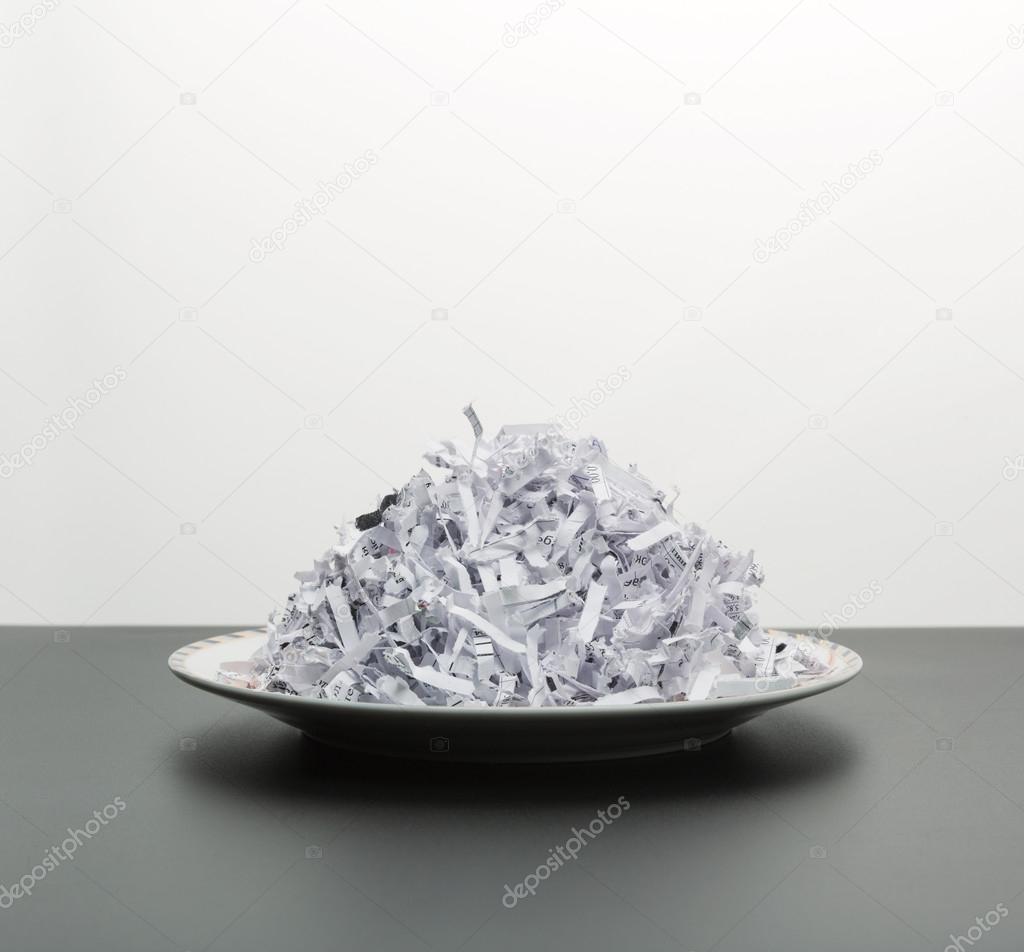 Heap of shredded papers on plate