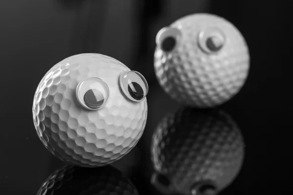 Duas bolas de golfe com olhos de plástico — Fotografia de Stock