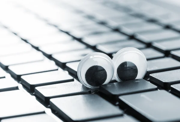 Keyboard with eyes of a modern laptop — Stock Photo, Image