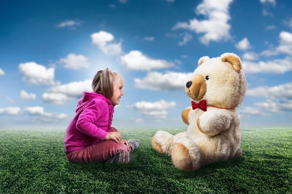 Girl sits with toy bear — Stock Photo, Image