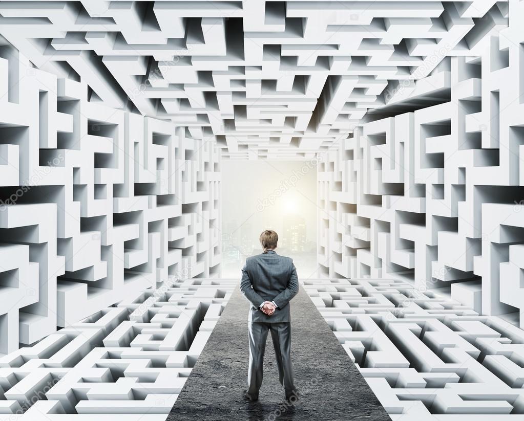 Businessman standing surrounded by labyrinth