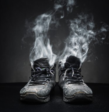 Old work shoes in smoke