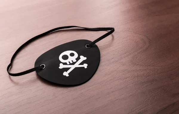 Pirate eyepatch on the table — Stock Photo, Image