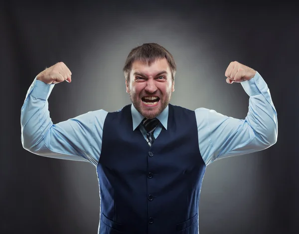 Businessman shows his muscles — Stock Photo, Image