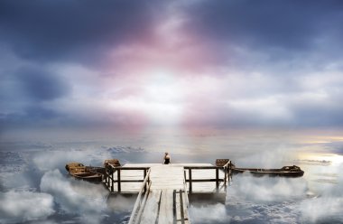 Woman sitting on an old pier clipart