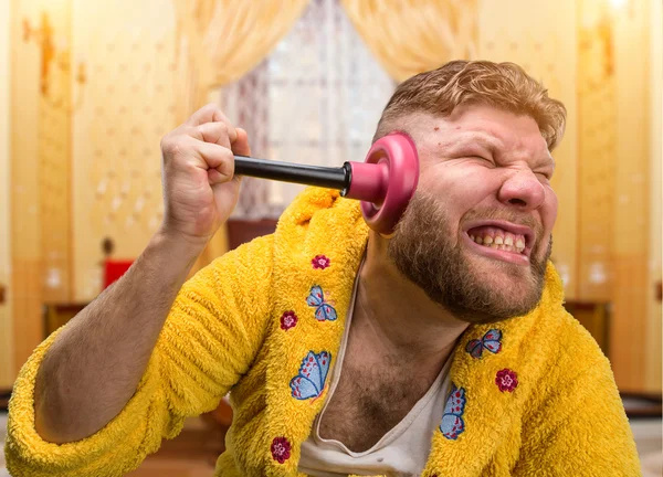 Strange man with a plunger in his ear — Stock Photo, Image