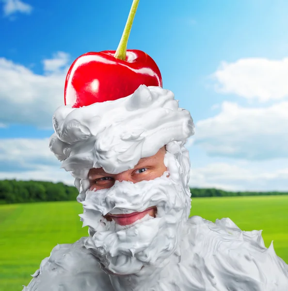 Smiling man with whipped cream and a cherry — Stock Photo, Image