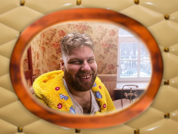 Man sits in the bathroom smiling — Stock Photo, Image