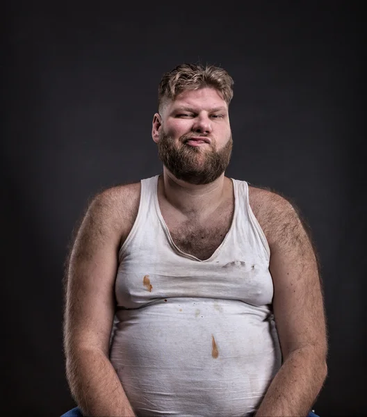 Fat man with beard in dirty shirt