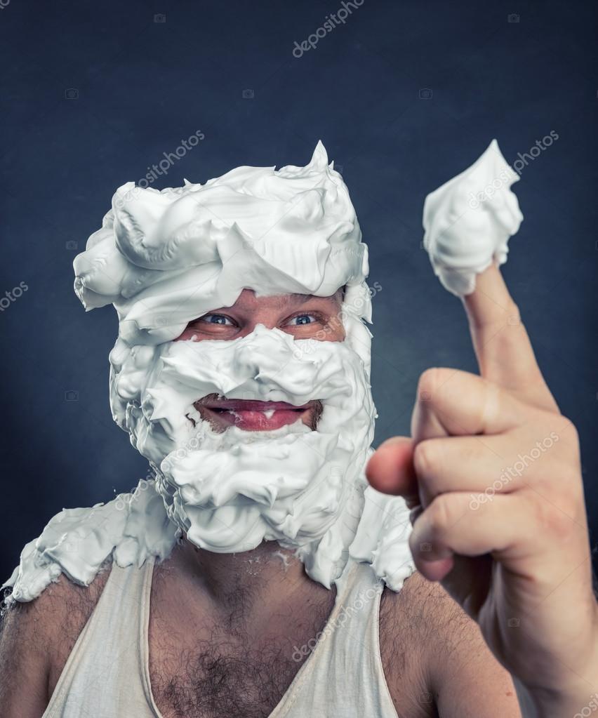 Man playing child's game with whipped cream on face Stock Photo