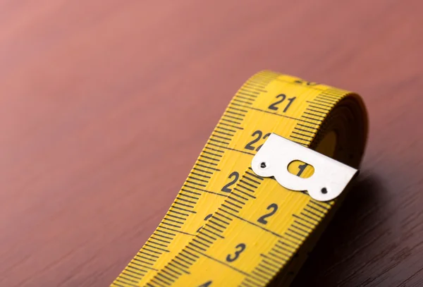 Measurement tape on wooden table — Stock Photo, Image