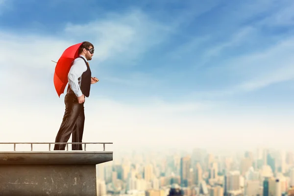 Man with red umbrella — Stock Photo, Image