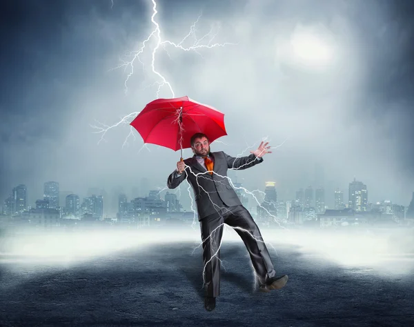 Businessman with red umbrella — Stock Photo, Image