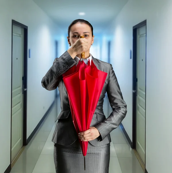 Businesswoman with closed umbrella — Stock Photo, Image