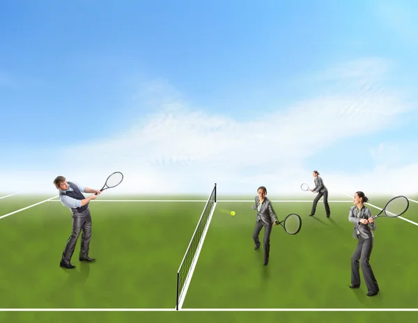 Businessman and businesswomen playing tennis — Stock Photo, Image