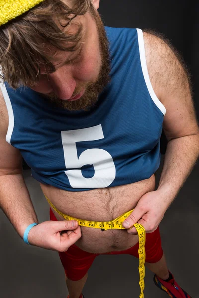 Fat man measuring belly — Stock Photo, Image