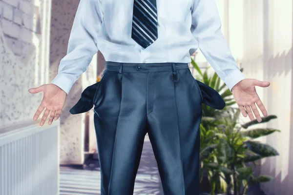 Businessman pulling out empty pockets — Stock Photo, Image